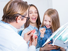 Woman and Child laughing with Dentist - Local Dentists